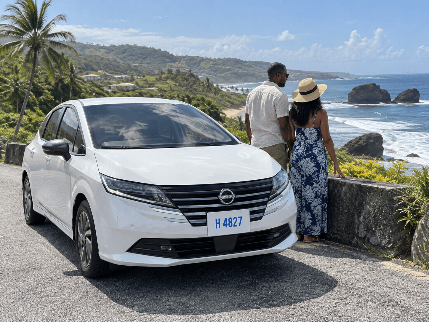 Couple exploring Bathsheba in a white Nissan Note rental car